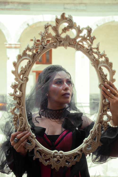 Free Artistic portrait of a woman holding an ornate mirror in Ciudad de México, highlighting gothic fashion. Stock Photo