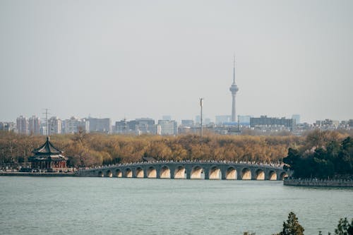 A bridge over a river with a city in the background