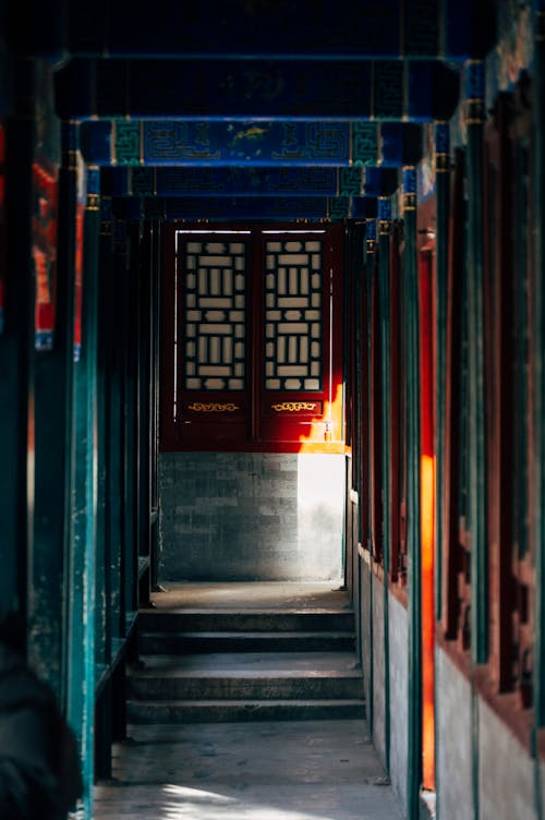 A hallway with a red door and blue light