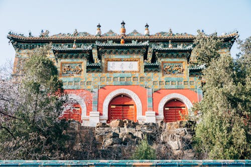 A chinese building with red and green trim