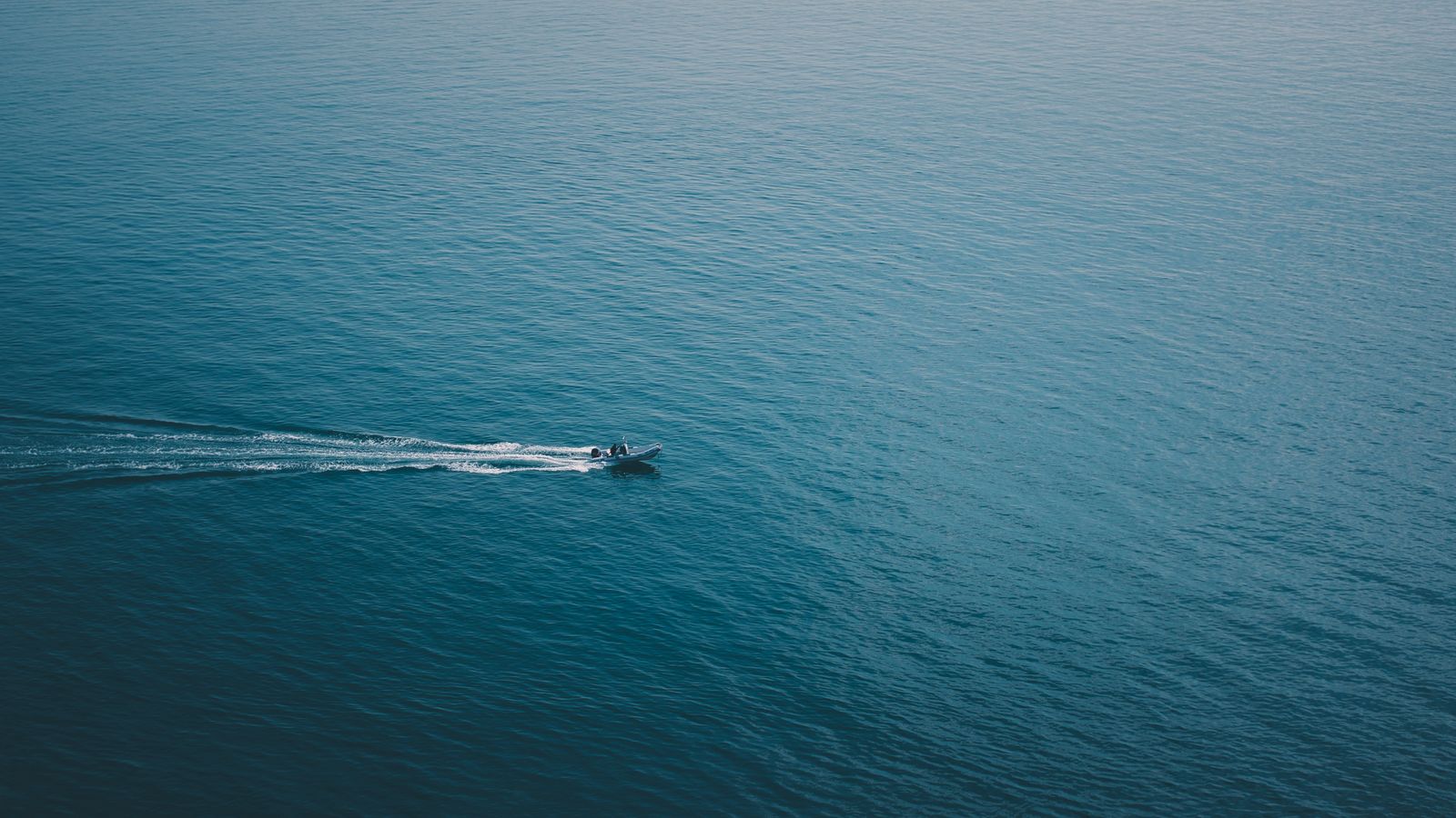 A lone boat sailing on open water, a real stock photo chosen for The Terminal List Season 2, which opens with Navy SEAL James Reece on course for Mozambique after Season 1 ends with him setting sail