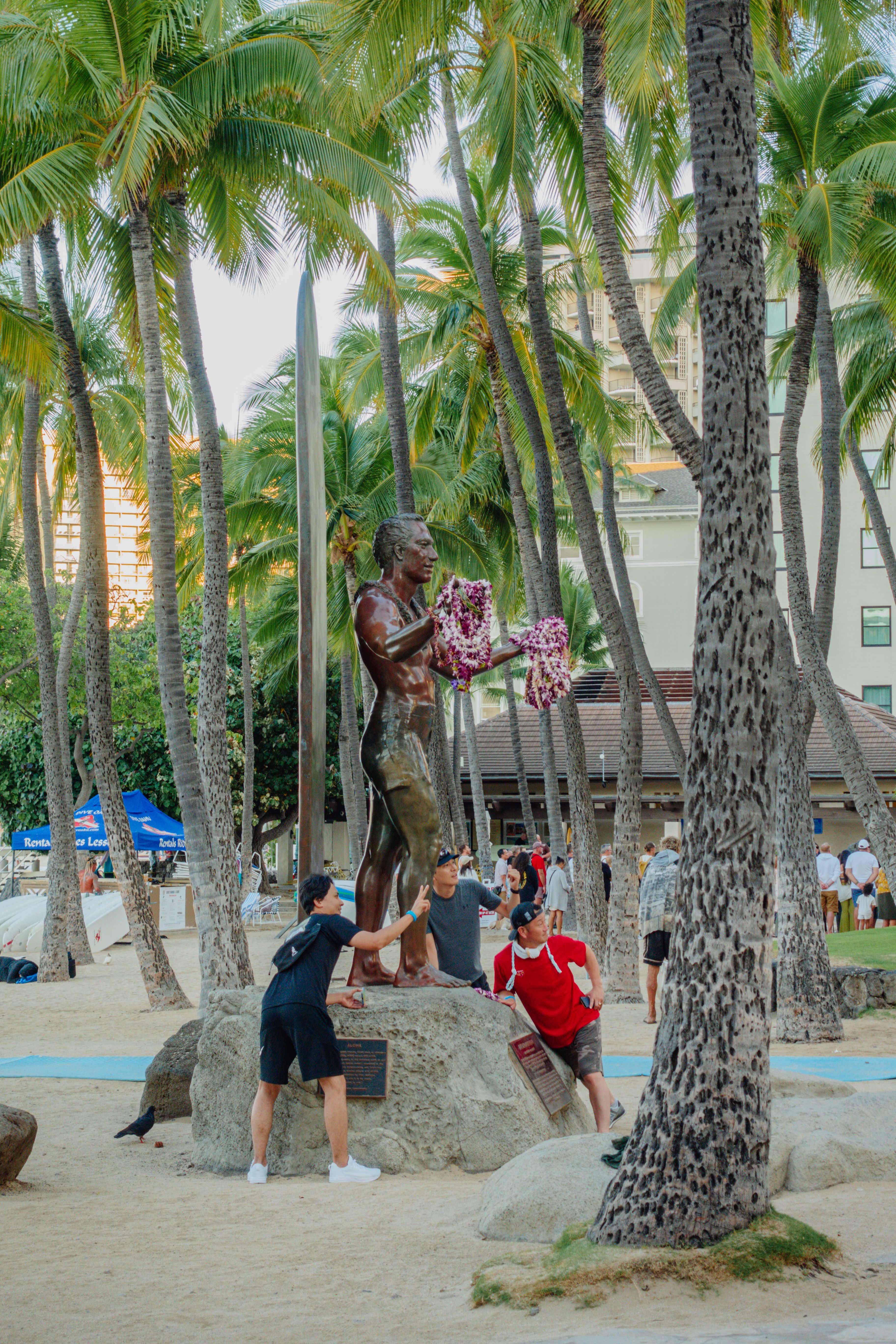 A statue of a man in a red shirt on a beach · Free Stock Photo