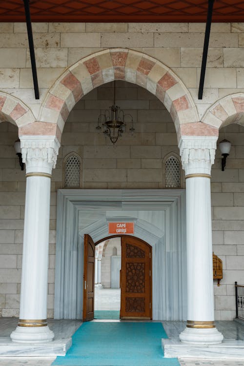 The entrance to a mosque with arches and columns