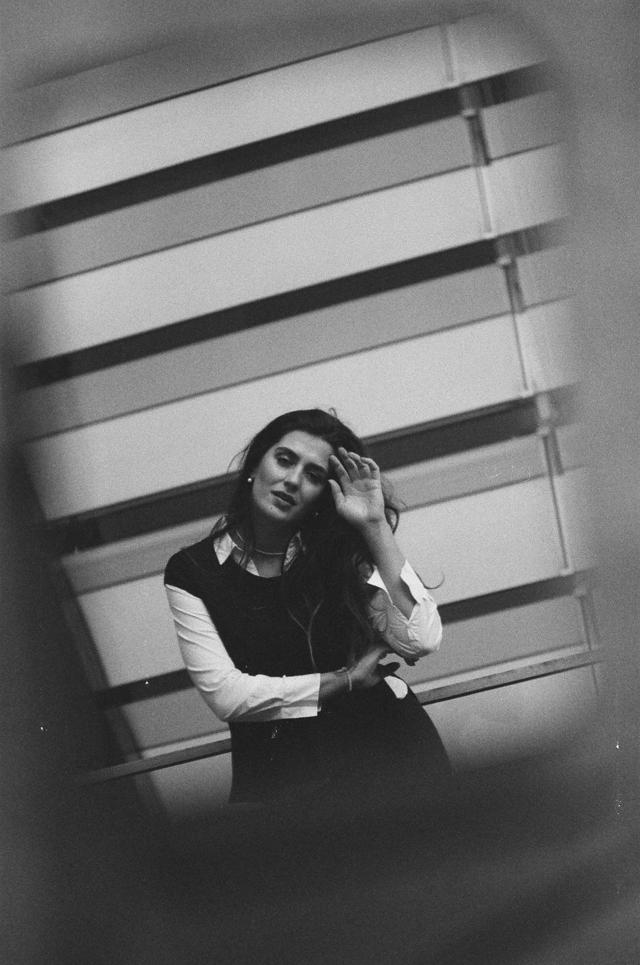 Artistic black and white portrait of a woman in Berlin showing reflection.