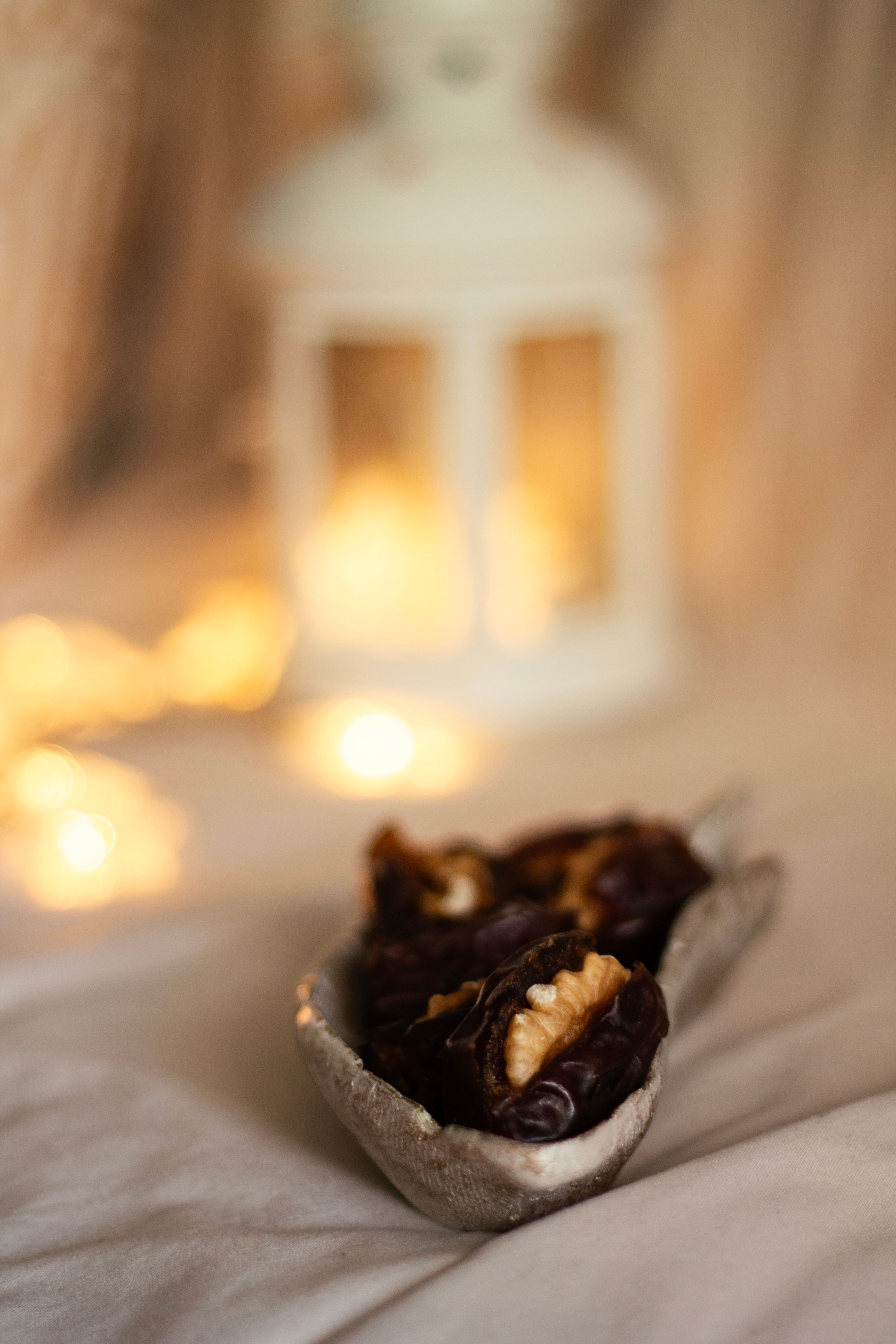 A warm scene of stuffed dates and candlelight, perfect for Ramadan celebrations.