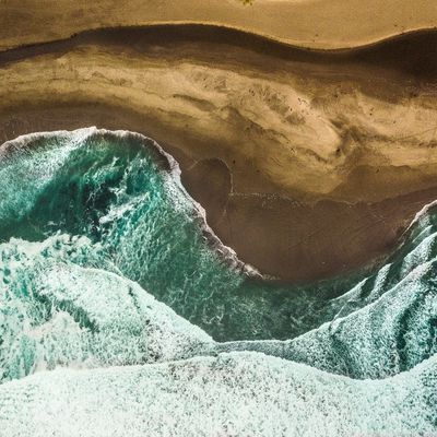 Turquoise waves meeting a sandy beach — photo by Dominic Rosenkranz on Pexels
