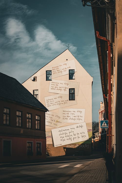 A street with a building with a lot of writing on it