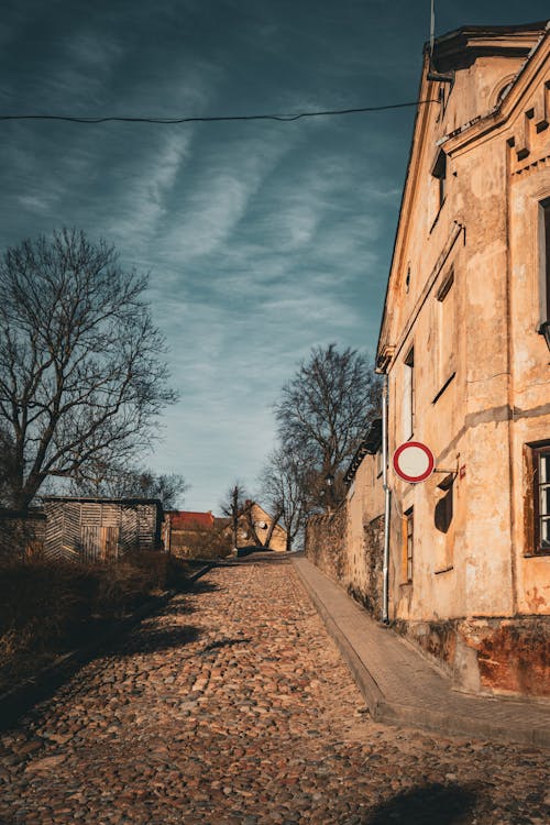 A street with a sign and a building