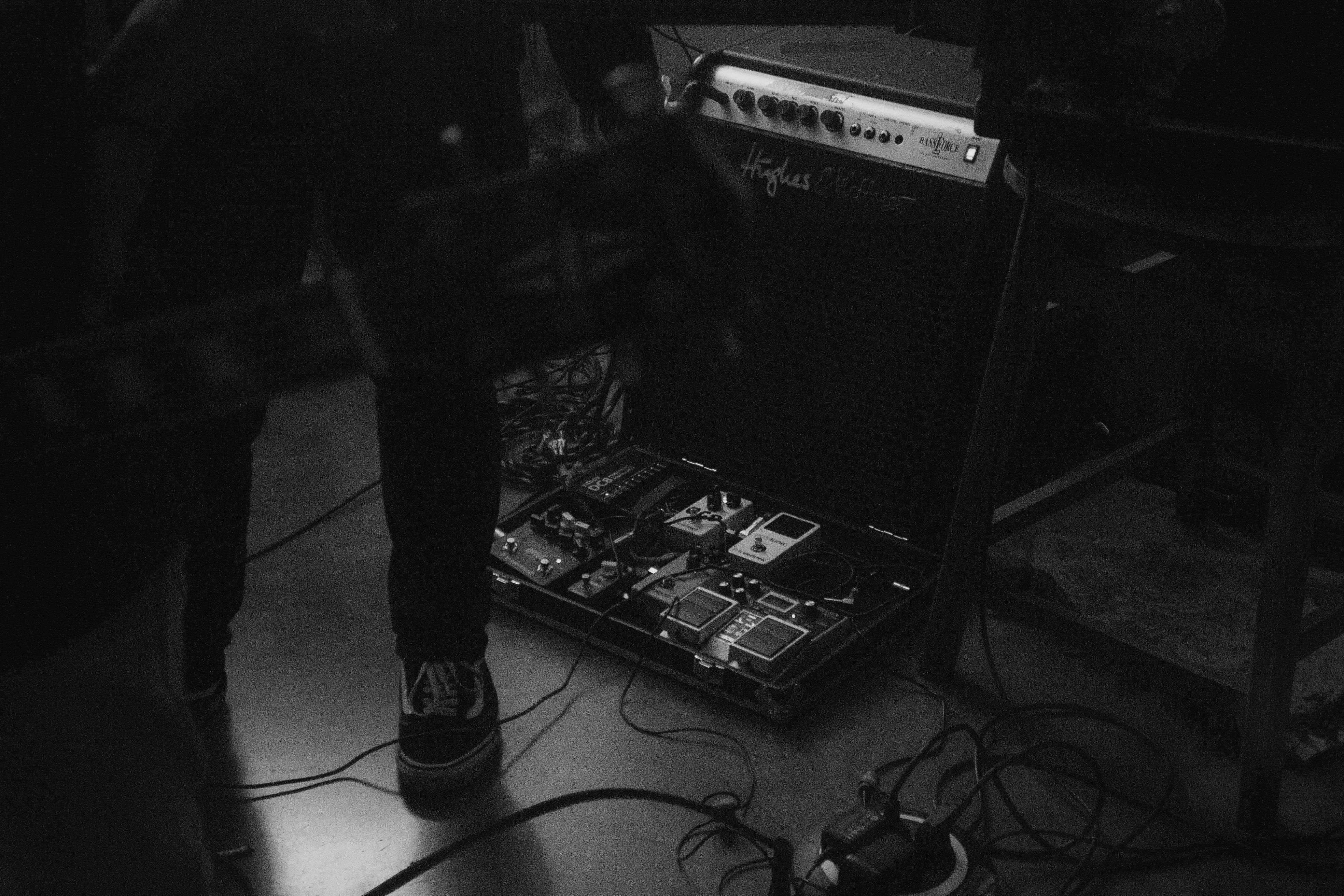 Black and white photo of a guitar setup with effects pedals, perfect for music enthusiasts.