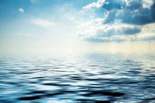 Free Clear Sky over Body of Water Stock Photo