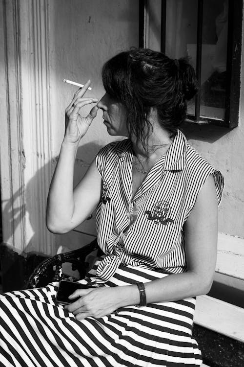 A woman smoking a cigarette outside