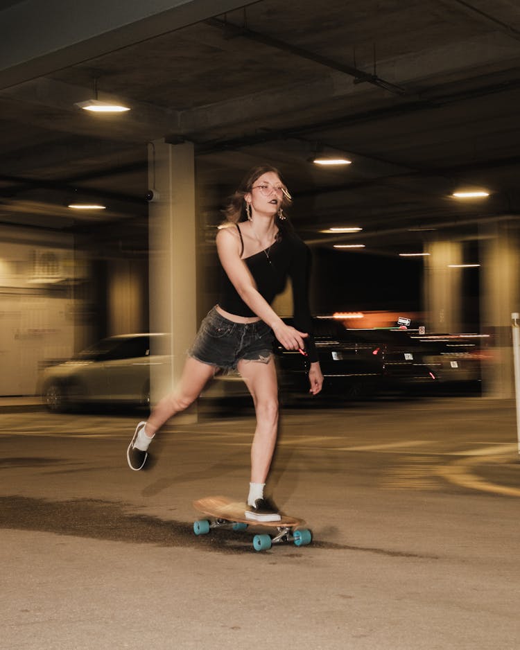 Woman On Skateboard On A Parking Lot