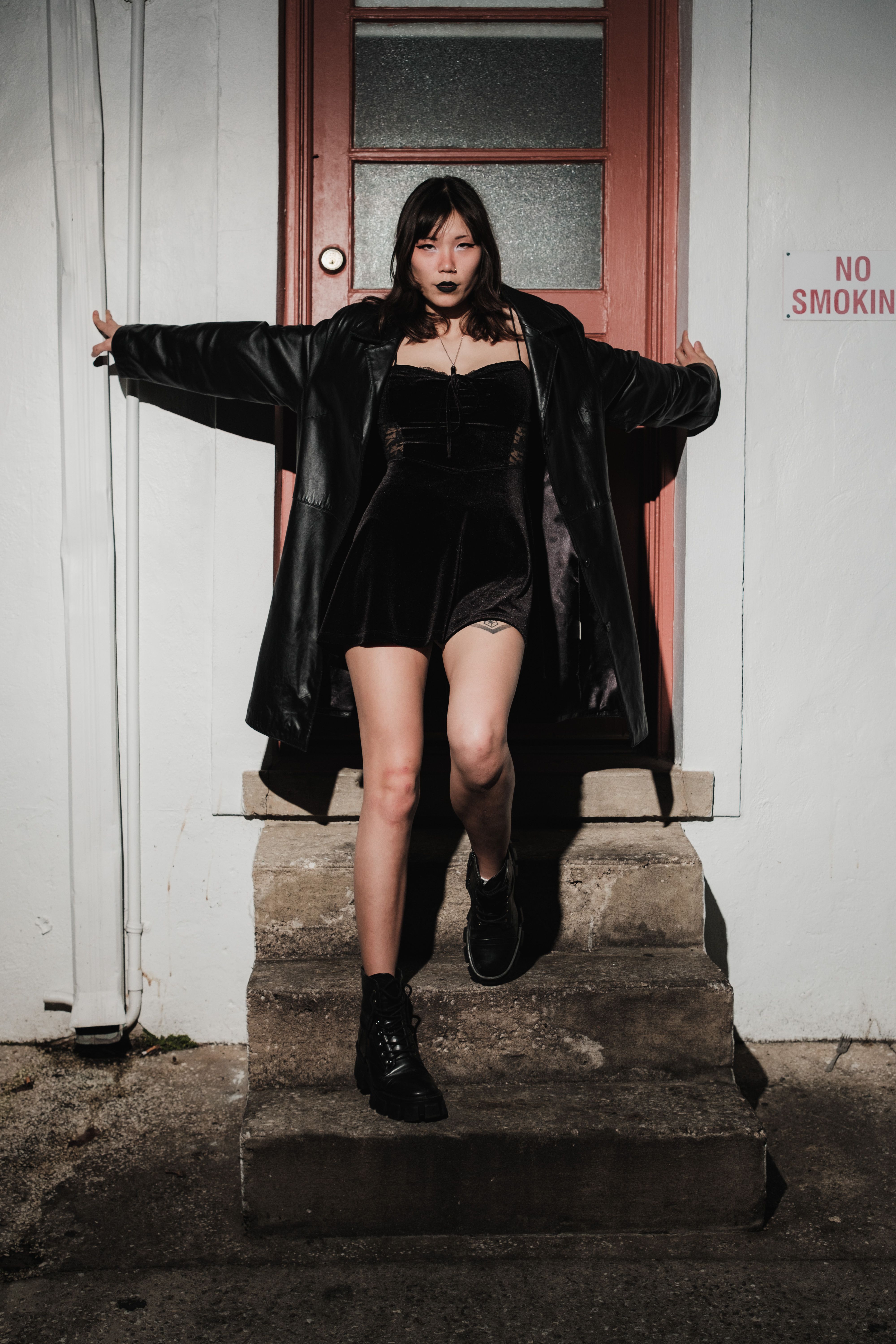 Woman in Black Jacket Posing on Stairs · Free Stock Photo