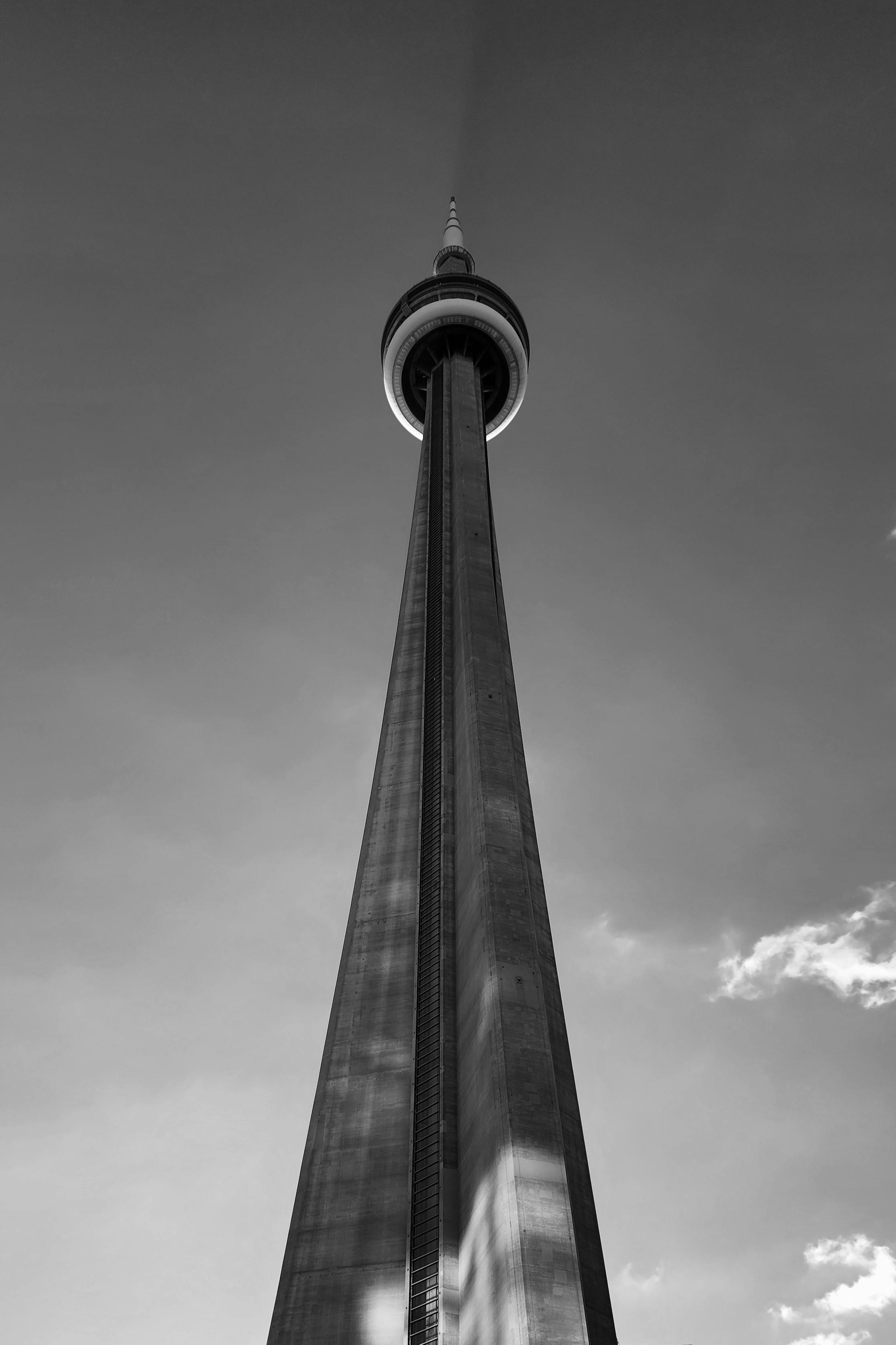 A dramatic low angle black and white view of Toronto's CN Tower.