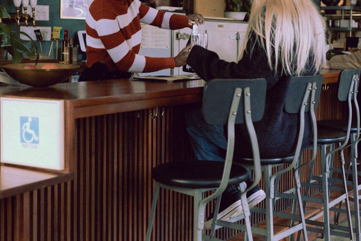 A woman sitting at a bar with a man