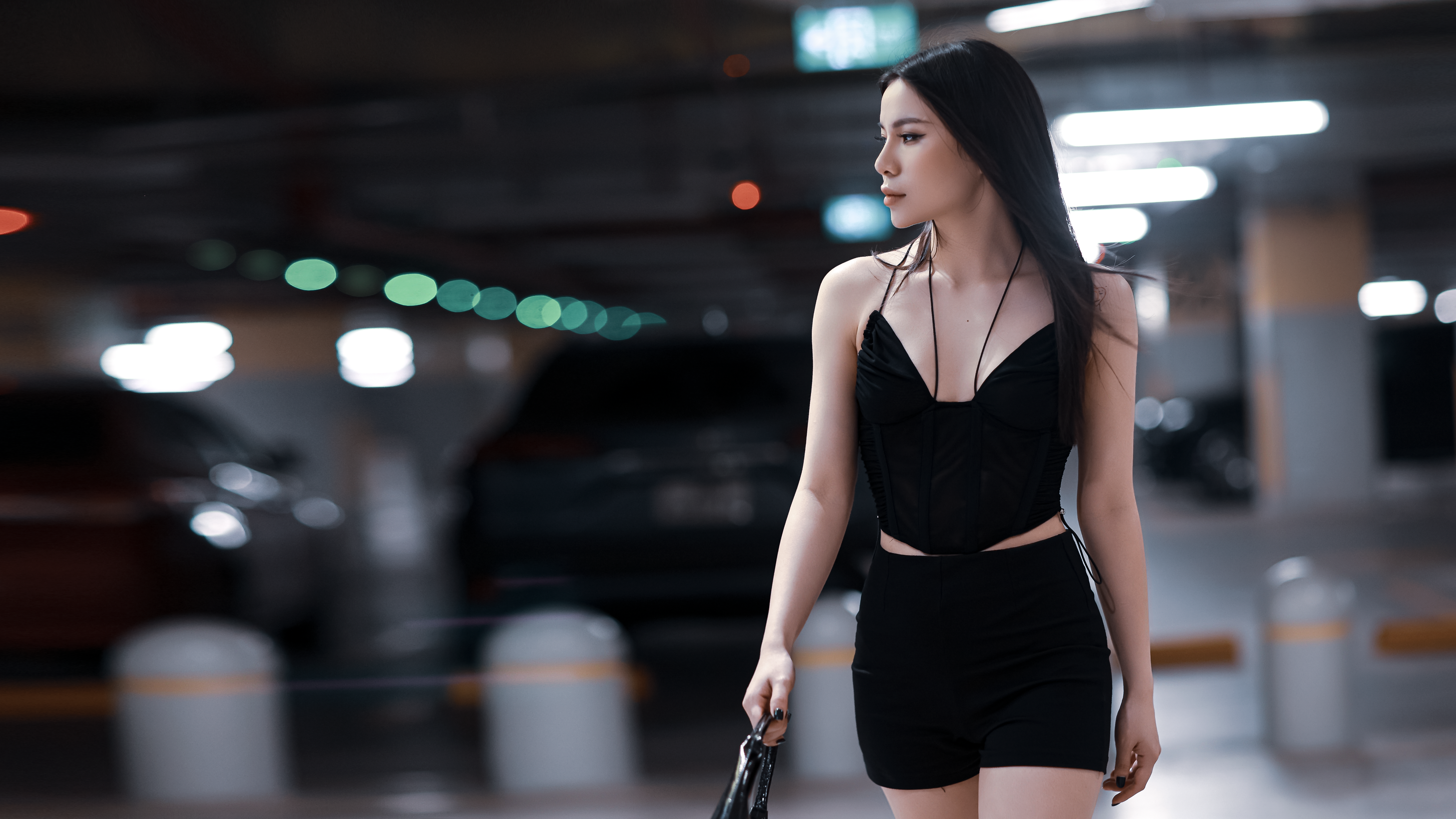 woman confidently walking through night market with phone in hand