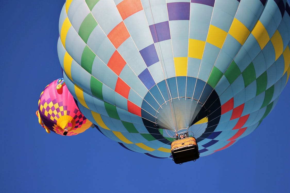 Blue and Multicolored Hot Air Balloon Under Blue Sky