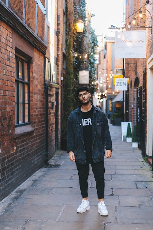 Man Wearing Jacket Standing Near Wall