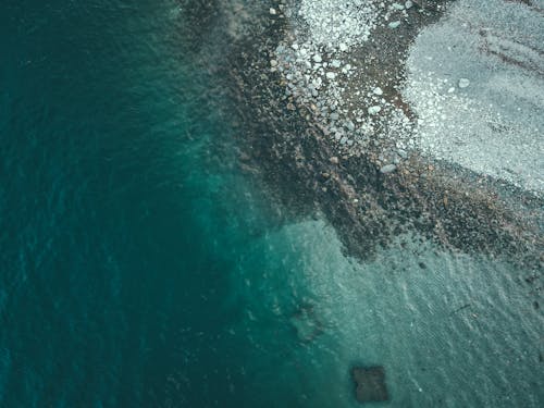 An aerial view of the ocean and rocks