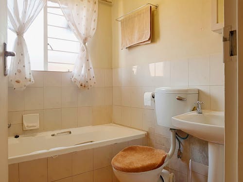 A bathroom with a toilet, sink and tub