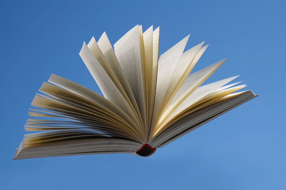 Open book representing stories written with AI