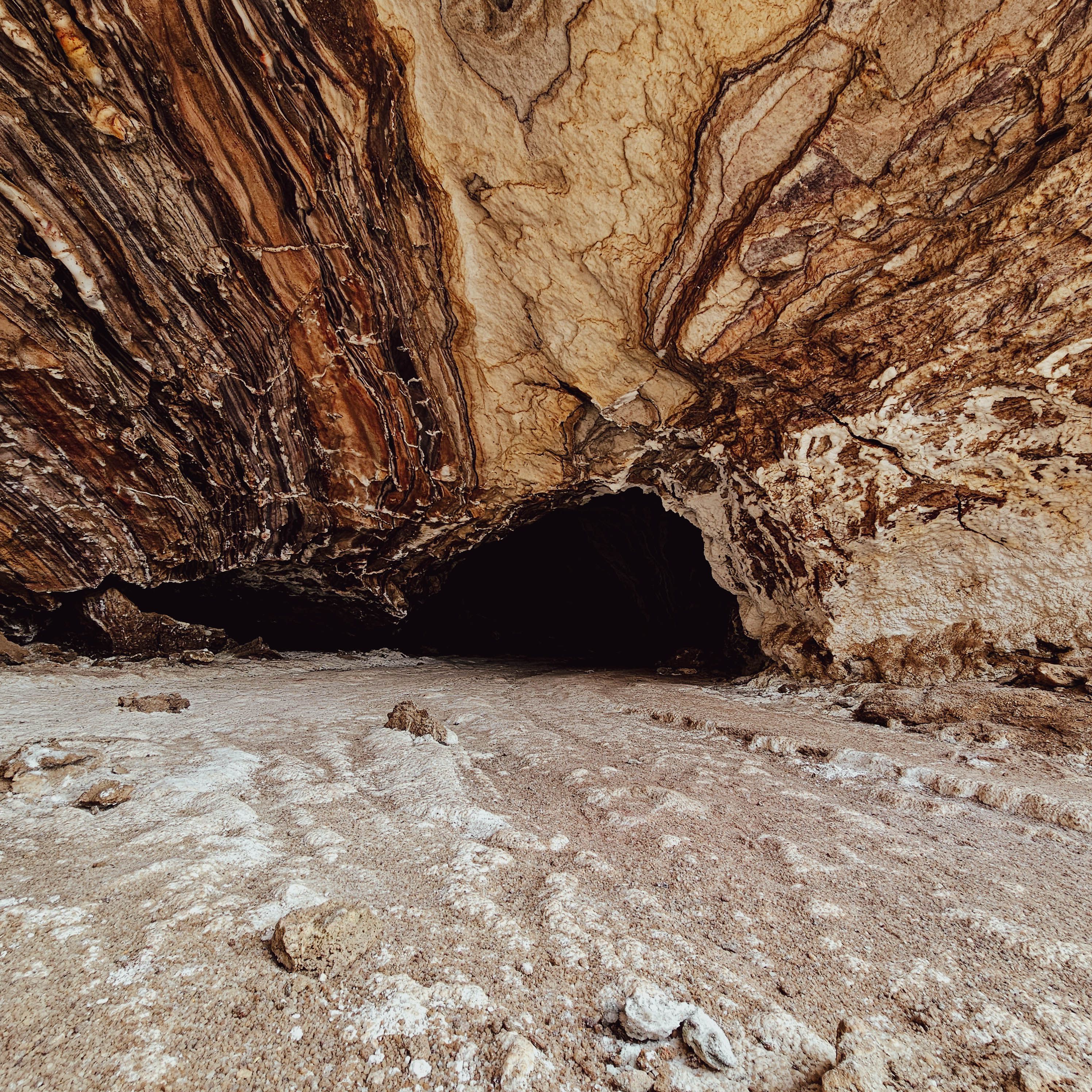 Explore the unique rock formations and natural arch on Qeshm Island, Iran, showcasing Earth's raw beauty.