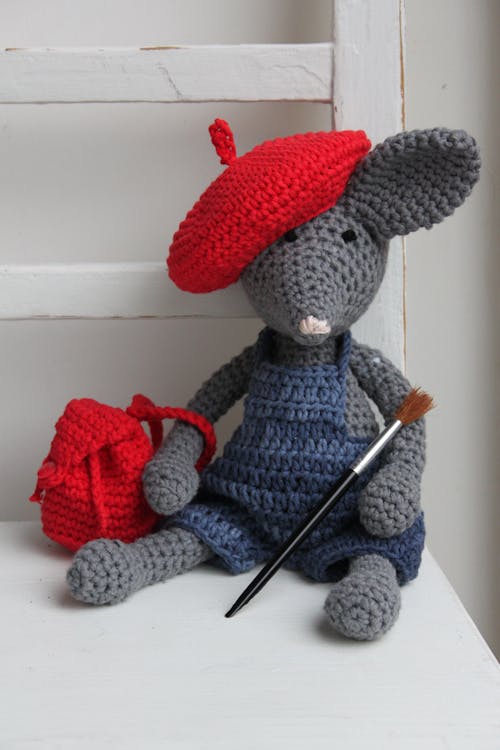 Gray Crochet Mouse With Red Backpack Plush Toy on White Surface