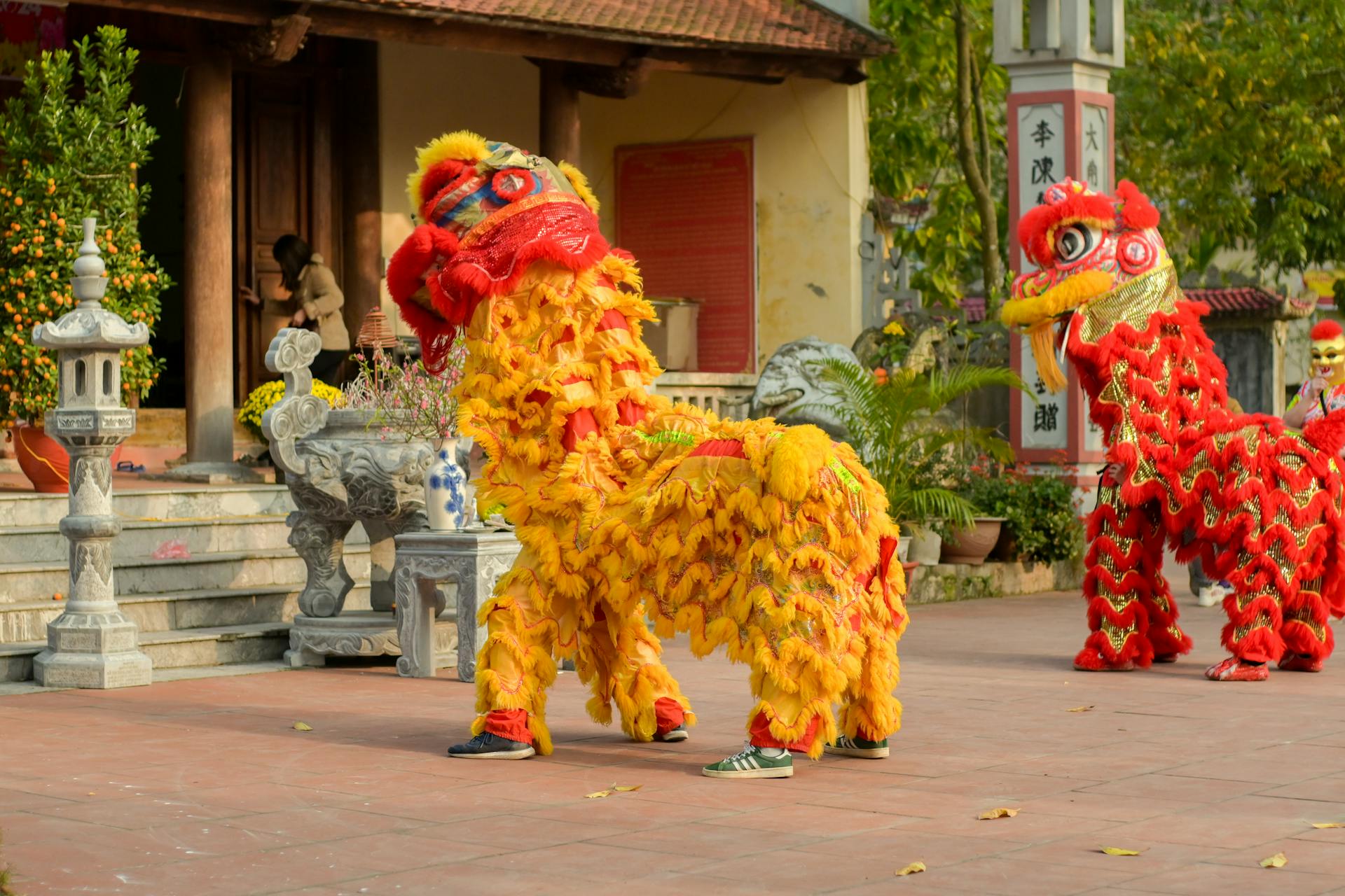 Performers in Chinese Guardian Lions Costumes in Front of the Temple