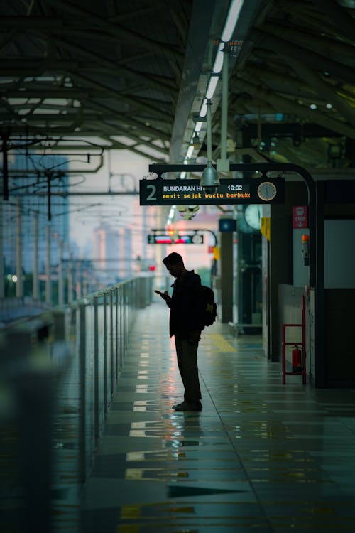 Man Standing at Railway Station