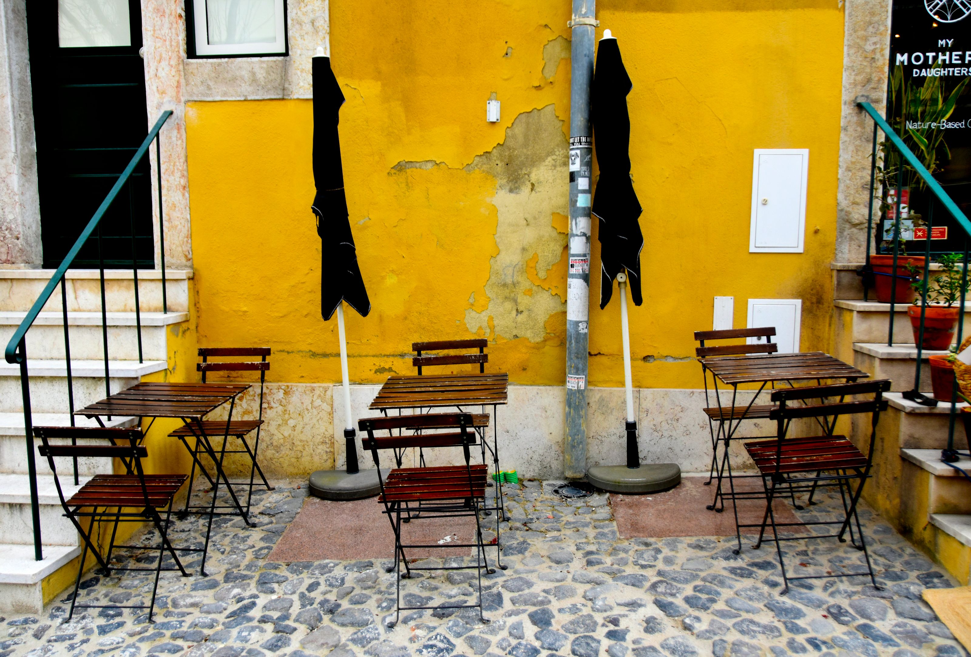 A Lisbon tasca table with bread, olives, house wine and a handwritten bill