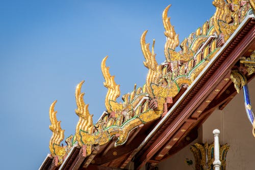 Golden roof of a temple with blue sky in the background