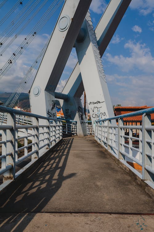 A bridge with a railing and a blue sky