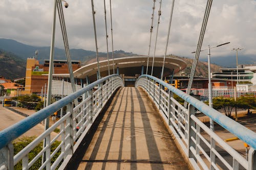 A bridge with a view of a city and stadium