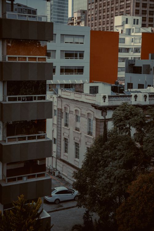 Free A blend of modern and classical architecture in Mexico City, showcasing urban residential life. Stock Photo