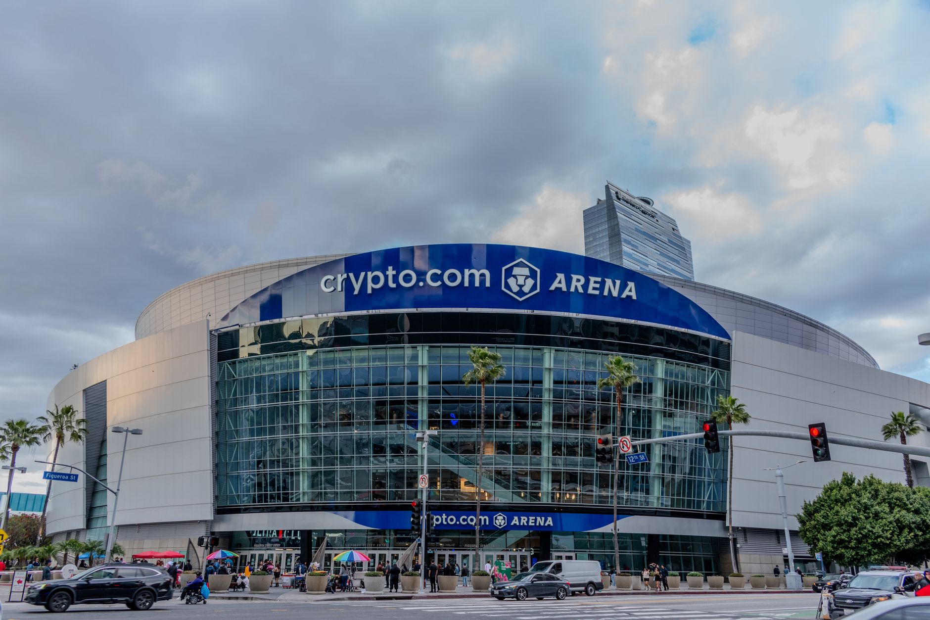 Los Angeles stadium exterior glowing before a FIFA World Cup 2026 evening match, fans gathering calmly