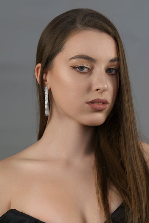 A woman with long hair and earrings