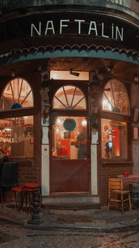 Cozy evening view of Naftalin Café entrance in Istanbul, Turkey.