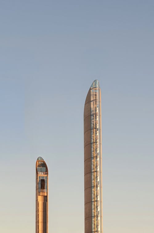 Two tall towers with a clock on top