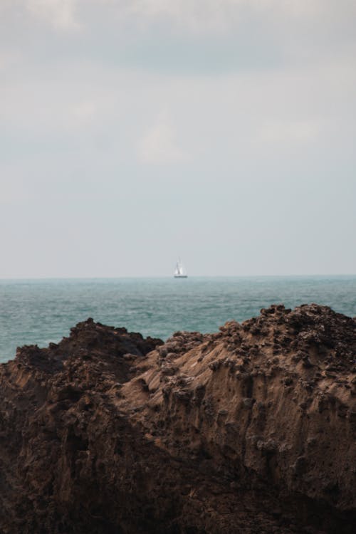 Free stock photo of ocean, rocks, sailboat