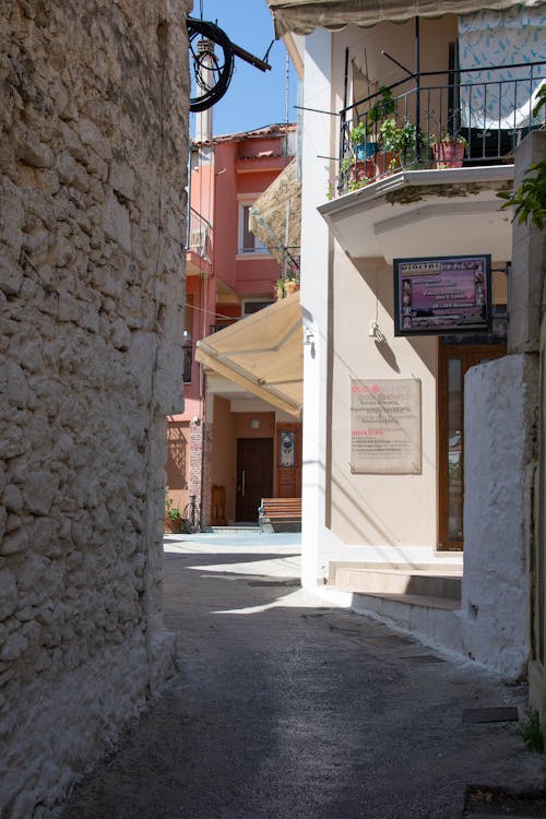 A narrow alley with a sign on it