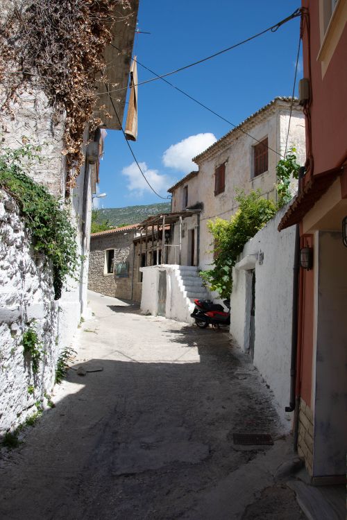 Free Idyllic narrow street in Parga, Greece, showcasing traditional architecture and bright summer skies. Stock Photo