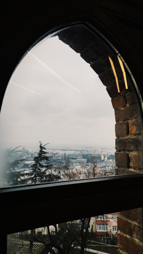 A view of a city from inside an arched window