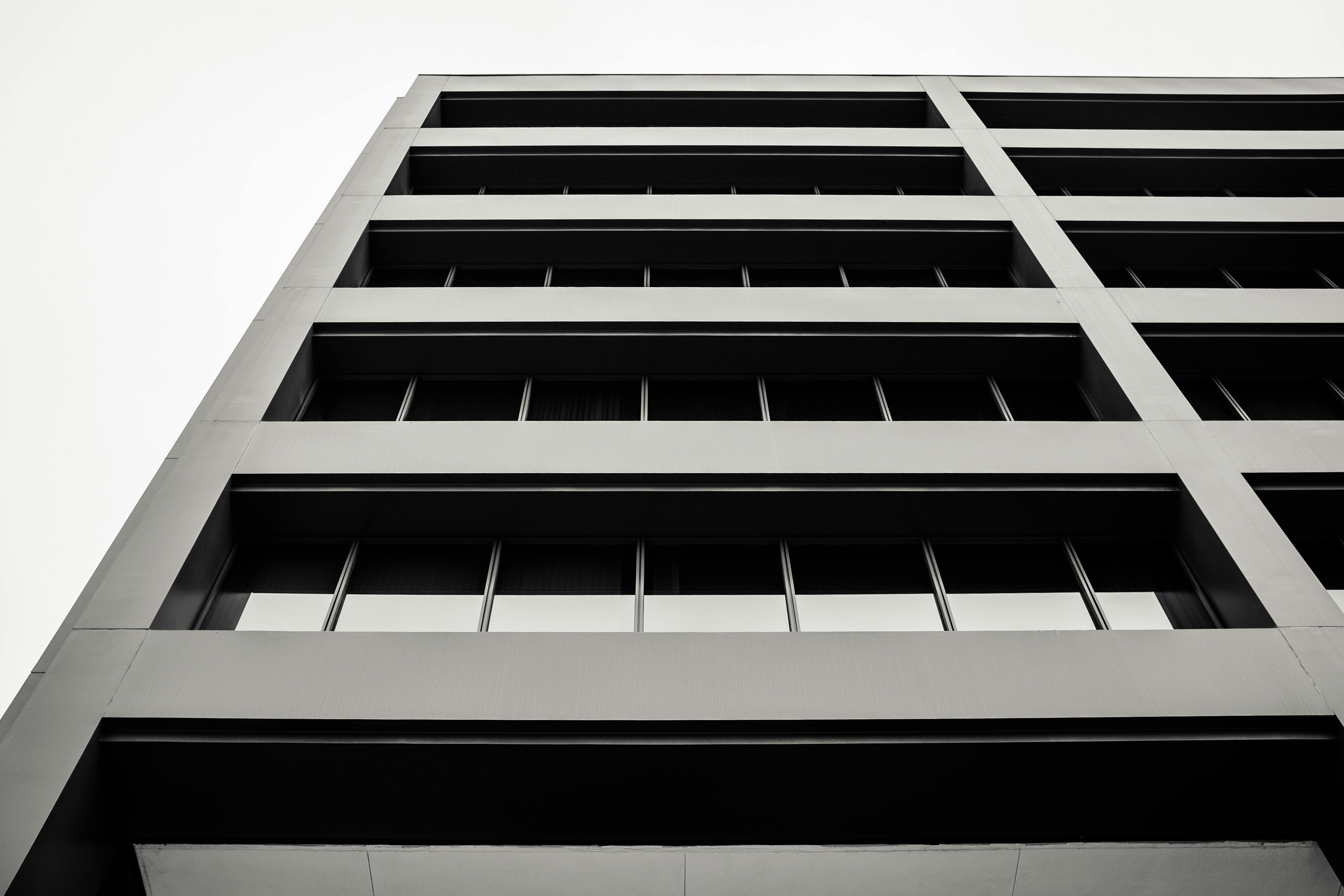 Low angle view of a modern building facade in Boise, ID, captured in black and white for a dramatic effect.