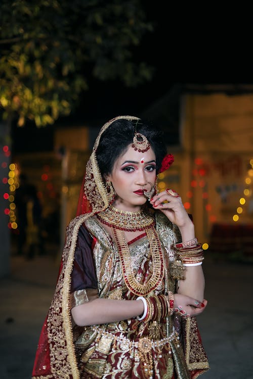 A woman in traditional indian attire poses for a photo