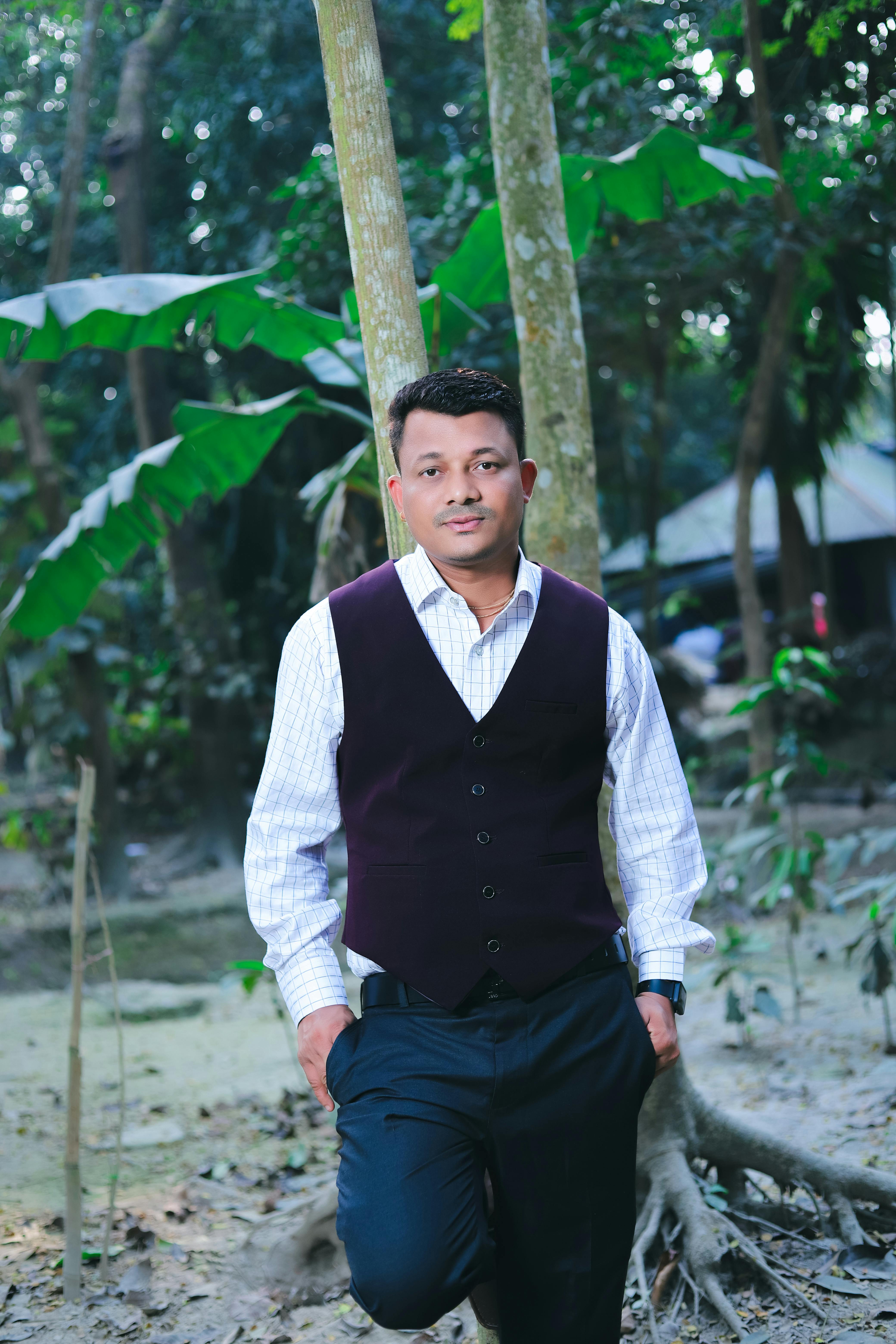 Portrait of a well-dressed man in a serene outdoor setting, Rajshahi Division, Bangladesh.