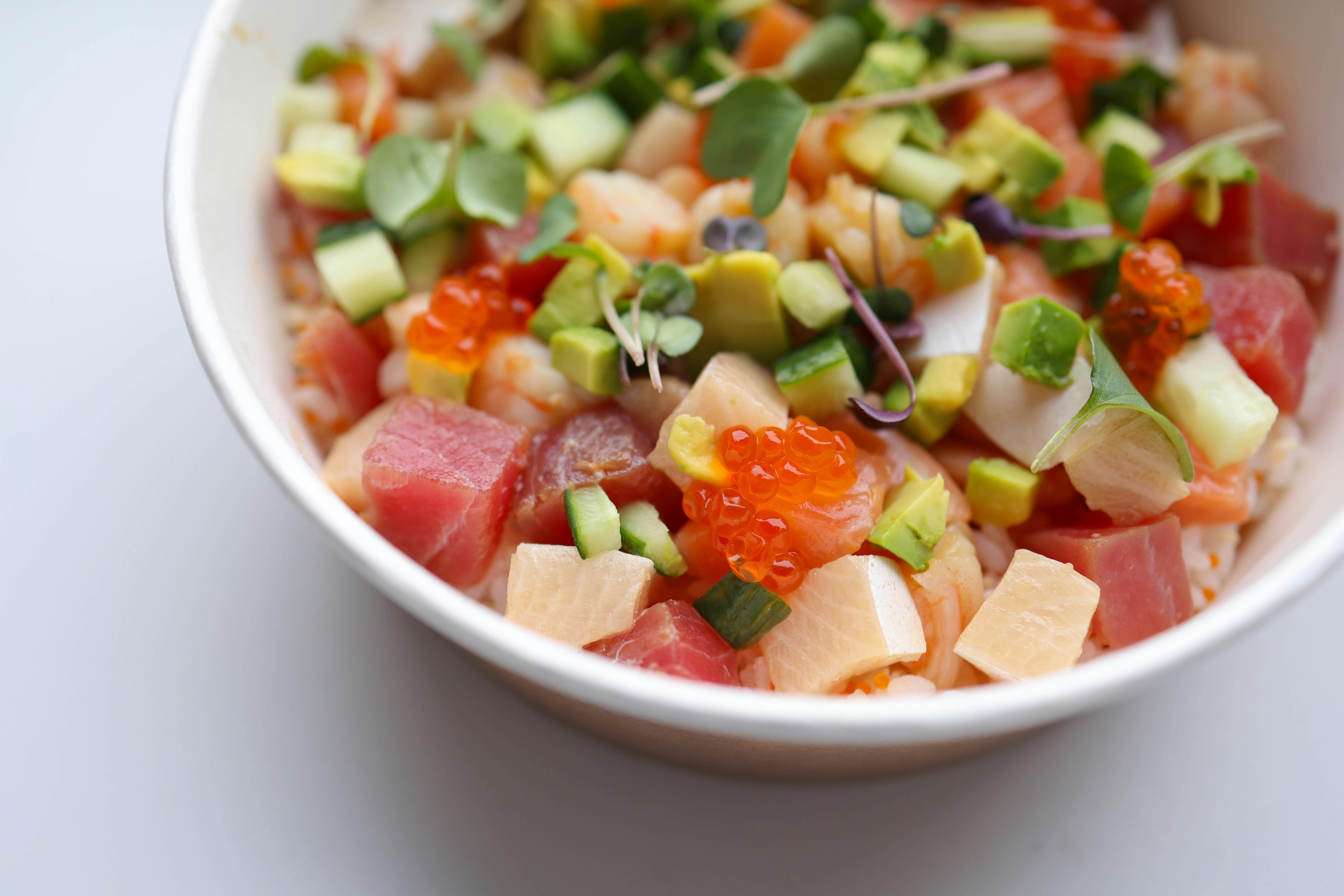 Salmon Poke Bowl With Brown Rice, Edamame, Pickled Ginger, And Seaweed Salad