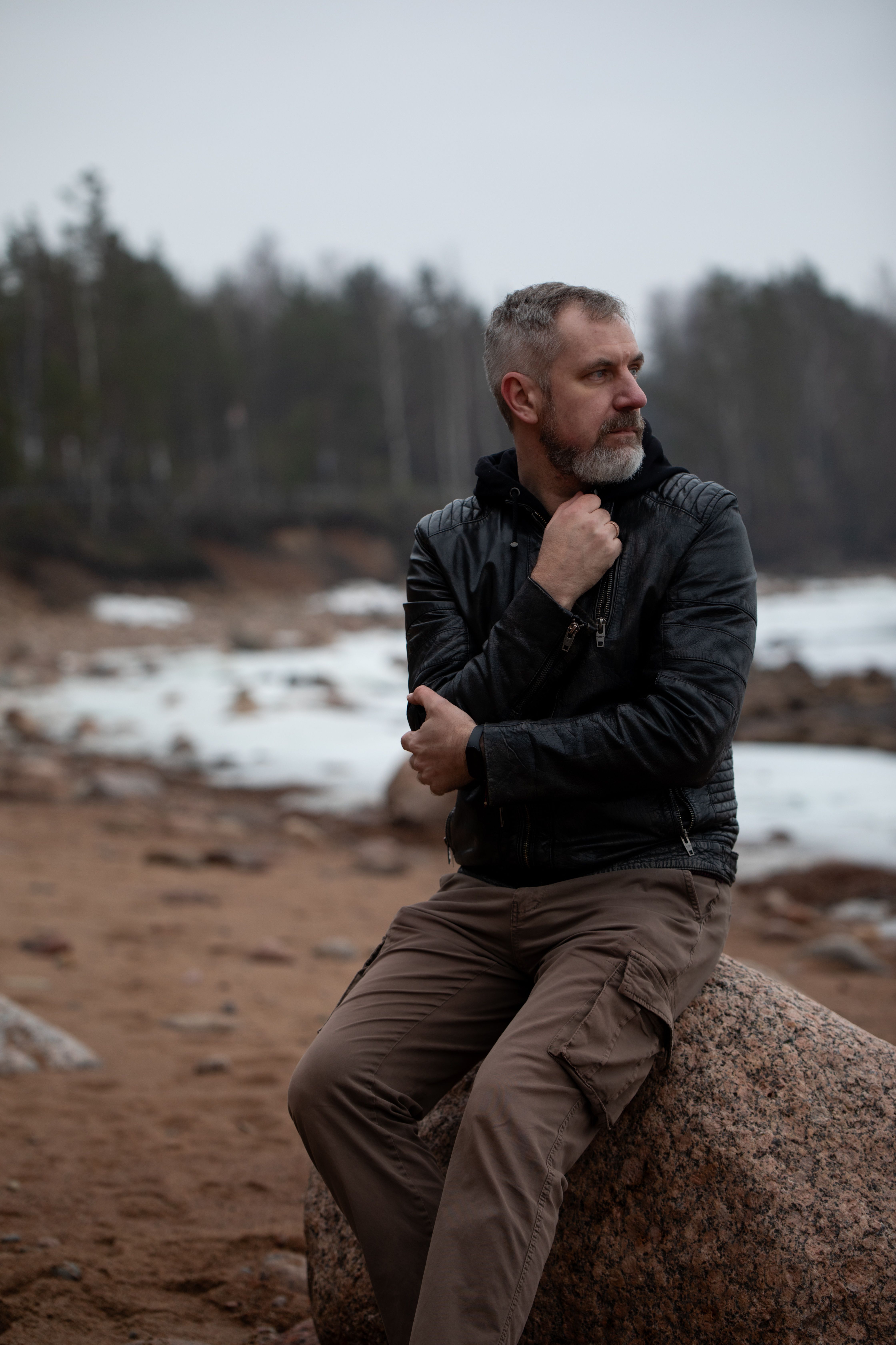 Portrait of Man Sitting on Rock · Free Stock Photo