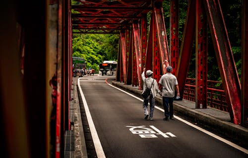 People crossing a red bridge
