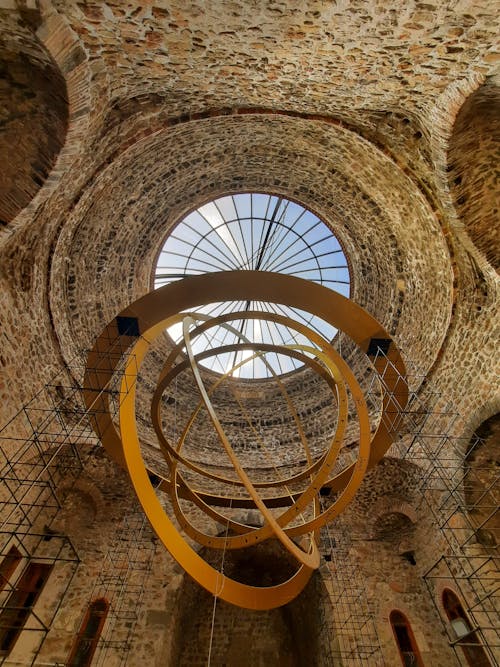 A large circular structure with a metal sculpture