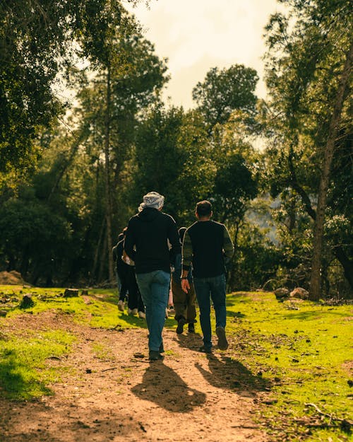 Two people walking down a path in the woods